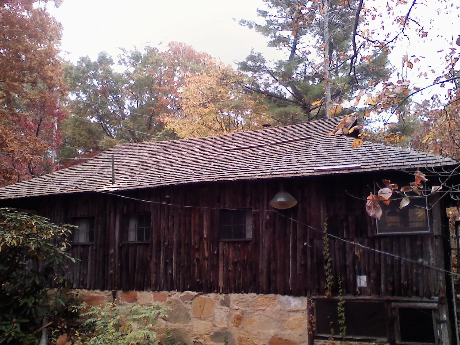 Weathered wood shake roof on a rustic board sided cabin in Hainesport